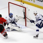 Chicago Blackhawks' Duncan Keith, bottom, scores past Tampa Bay Lightning goalie Ben Bishop, center, as Lightning's Andrej Sustr, of the Czech Republic, watches during the second period in Game 6 of the NHL hockey Stanley Cup Final series on Monday, June 15, 2015, in Chicago. (AP Photo/Charles Rex Arbogast)