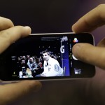 New England Patriots' Rob Gronkowski has his photo taken with a cell phone during media day for NFL Super Bowl XLIX football game Tuesday, Jan. 27, 2015, in Phoenix. (AP Photo/David J. Phillip)
