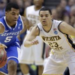 Kentucky guard Andrew Harrison (5) and Wichita State guard Fred VanVleet (23) go for a loose ball during the first half of a third-round game of the NCAA college basketball tournament Sunday, March 23, 2014, in St. Louis. (AP Photo/Charlie Riedel)