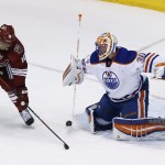  Edmonton Oilers goalie Ben Scrivens (30) makes a save on a shot by Phoenix Coyotes' Martin Erat (10), of the Czech Republic, during the third period of an NHL hockey game, Friday, April 4, 2014, in Glendale, Ariz. The Oilers defeated the Coyotes in a shootout, 3-2. (AP Photo/Ross D. Franklin)