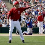 Actor Will Ferrell dressed as a Los Angeles Angels player yells to ball players during a spring training baseball exhibition game against the Chicago Cubs in Tempe, Ariz., on Thursday, March 12, 2015. The comedian plans to play every position while making appearances at five Arizona spring training games on Thursday. (AP Photo/Chris Carlson)
