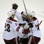 Arizona Coyotes' Oliver Edman-Larsson (23) Sam Gagner, middle, and John Moore (17) celebrate a game-winning goal by Gagner during the overtime session of an NHL hockey game against the Buffalo Sabres, Thursday, March 26, 2015, in Buffalo, N.Y. The Coyotes won 4-3. (AP Photo/Gary Wiepert)