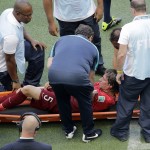 Portugal's Fabio Coentrao is taken away on a stretcher after being injured during the group G World Cup soccer match between Germany and Portugal at the Arena Fonte Nova in Salvador, Brazil, Monday, June 16, 2014. (AP Photo/Christophe Ena)