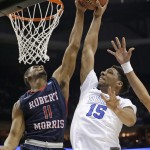 Robert Morris's Rodney Pryor (11) blocks a shot by Duke's Jahlil Okafor (15) during the first half of an NCAA tournament college basketball game in the Round of 64 in Charlotte, N.C., Friday, March 20, 2015. (AP Photo/Gerald Herbert)