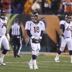 Denver Broncos quarterback Peyton Manning (18) walks off the field after throwing an interception during the second half of an NFL football game against the Cincinnati Bengals on Monday, Dec. 22, 2014, in Cincinnati. (AP Photo/Michael Conroy)