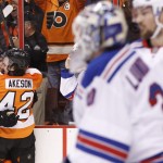 Philadelphia Flyers' Matt Read, left, celebrates his goal against New York Rangers' Henrik Lundqvist, front right, of Sweden, with Jason Akeson (42) during the first period in Game 4 of an NHL hockey first-round playoff series on Friday, April 25, 2014, in Philadelphia. (AP Photo/Chris Szagola)