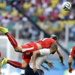  Switzerland's Valon Behrami jumps over France's Karim Benzema to head the ball during the group E World Cup soccer match between Switzerland and France at the Arena Fonte Nova in Salvador, Brazil, Friday, June 20, 2014. (AP Photo/Natacha Pisarenko)