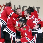Members of the Chicago Blackhawks celebrate after defeating the Tampa Bay Lightning in Game 6 of the NHL hockey Stanley Cup Final series on Monday, June 15, 2015, in Chicago. The Blackhawks defeated the Lightning 2-0 to win the series 4-2. (AP Photo/Charles Rex Arbogast)