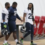 Seattle Seahawks' Richard Sherman (25), Jimmy Stanton, center, and Kam Chancellor (31) arrive for team practice for NFL Super Bowl XLIX football game, Thursday, Jan. 29, 2015, in Tempe, Ariz. The Seahawks play the New England Patriots in Super Bowl XLIX on Sunday, Feb. 1, 2015. (AP Photo/Matt York)