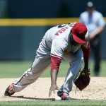 Arizona Diamondbacks starting pitcher Rubby De La Rosa reaches down to pick up the ball after stopping a ground ball off the bat of Colorado Rockies' Rafael Ynoa in the first inning of a baseball game Thursday, June 25, 2015, in Denver. Ynoa was out at first on the play. (AP Photo/David Zalubowski)