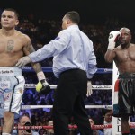 Marcos Maidana, left, is sent to his corner by referee Tony Weeks, center, after accidentally head butting Floyd Mayweather Jr. in their WBC-WBA welterweight title boxing fight Saturday, May 3, 2014, in Las Vegas. (AP Photo/Isaac Brekken)