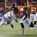 Indianapolis Colts running back Ahmad Bradshaw is knocked out of bounds by Denver Broncos free safety Rahim Moore (26) during the second half of an NFL divisional playoff football game, Sunday, Jan. 11, 2015, in Denver. (AP Photo/Jack Dempsey)

