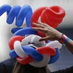 Kimberly O'Kane, of Stony Point, N.Y., dons a red, white and blue balloon hat for the Fourth of July while attending a baseball game between the Tampa Bay Rays and the New York Yankees, Saturday, July 4, 2015, in New York. (AP Photo/Julie Jacobson)
