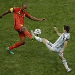 Belgium's Vincent Kompany, left, and Argentina's Lionel Messi fight for the ball during the World Cup quarterfinal soccer match between Argentina and Belgium at the Estadio Nacional in Brasilia, Brazil, Saturday, July 5, 2014. (AP Photo/Thanassis Stavrakis)