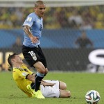 Colombia's James Rodriguez, left, falls to the ground after colliding with Uruguay's Maxi Pereira during the World Cup round of 16 soccer match between Colombia and Uruguay at the Maracana Stadium in Rio de Janeiro, Brazil, Saturday, June 28, 2014. (AP Photo/Matt Dunham)
