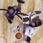 New Orleans Pelicans guard Quincy Pondexter, center, goes to the basket between Phoenix Suns forward T.J. Warren , top left, forward Brandan Wright, and Pelicans center Omer Asik (3) in the first half of an NBA basketball game in New Orleans, Friday, April 10, 2015. (AP Photo/Gerald Herbert)
