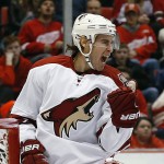 Arizona Coyotes defenseman John Moore celebrates his goal against the Detroit Red Wings during the first period of an NHL hockey game in Detroit on Tuesday, March 24, 2015. (AP Photo/Paul Sancya)