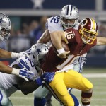 Washington Redskins quarterback Colt McCoy (16) is caught in the grasp of Dallas Cowboys defensive tackle Henry Melton (69) as Tyrone Crawford (98) and Jeremy Mincey (92) come over to help during the first half of an NFL football game, Monday, Oct. 27, 2014, in Arlington, Texas. (AP Photo/Brandon Wade)