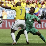 Ivory Coast's Max Gradel, right, battles with Colombia's Pablo Armero for the ball during the group C World Cup soccer match between Colombia and Ivory Coast at the Estadio Nacional in Brasilia, Brazil, Thursday, June 19, 2014. (AP Photo/Martin Mejia)