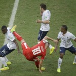  Switzerland's Granit Xhaka, center, falls after challenging for the ball with France's Blaise Matuidi, Yohan Cabaye and Patrice Evra, from left, during the group E World Cup soccer match between Switzerland and France at the Arena Fonte Nova in Salvador, Brazil, Friday, June 20, 2014. (AP Photo/Sergei Grits)
