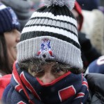 New England Patriots fan Sam Ketchum, of Lowell, Mass., is bundled up as she waits for the team to arrive during an NFL football send-off rally at City Hall in Boston Monday, Jan. 26, 2015. The Patriots play the Seattle Seahawks in Sunday's Super Bowl XLIX in Glendale, Ariz. (AP Photo/Charles Krupa)
