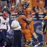 UTSA's David Morgan (82) is lifted by teammate Cody Harris (68) after scoring a touchdown against Arizona during the first half of an NCAA college football game, Thursday, Sept. 4, 2014, in San Antonio. (AP Photo/Eric Gay)