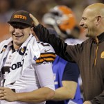 Cleveland Browns head coach Mike Pettine, right, pats quarterback Johnny Manziel on the head as they leave the field at halftime of a preseason NFL football game against the Chicago Bears, Thursday, Aug. 28, 2014, in Cleveland. (AP Photo/Tony Dejak)