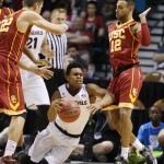 Arizona State's Tra Holder, center, falls between Southern California's Nikola Jovanovic, left, and Julian Jacobs in the first half of an NCAA college basketball game in the first round of the Pac-12 conference tournament Wednesday, March 11, 2015, in Las Vegas. (AP Photo/John Locher)