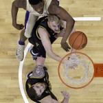 Washington's Shawn Kemp Jr., top reaches for a loose ball with Arizona State's Jonathan Gilling, center, and Eric Jacobsen in the first half of an NCAA college basketball game Sunday, Feb. 15, 2015, in Seattle. (AP Photo/Elaine Thompson)