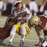 USC running back Javorius Allen (37) is tackled by Boston College defensive tackle Truman Gutapfel (97) and linebacker Steven Daniels, left, during the first quarter of their NCAA college football game Saturday, Sept. 13, 2014 in Boston. (AP Photo/Stephan Savoia)
