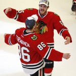 Chicago Blackhawks' Andrew Shaw, top, and teammate Teuvo Teravainen, of Finland, celebrate after defeating the Tampa Bay Lightning in Game 6 of the NHL hockey Stanley Cup Final series on Monday, June 15, 2015, in Chicago. The Blackhawks defeated the Lightning 2-0 to win the series 4-2. (AP Photo/Charles Rex Arbogast)

