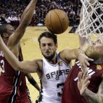San Antonio Spurs guard Marco Belinelli (3) is caught between Miami Heat guard Dwyane Wade (3) and forward Chris Andersen (11) during the first half in Game 1 of the NBA basketball finals on Thursday, June 5, 2014, in San Antonio. (AP Photo/Eric Gay, Pool)