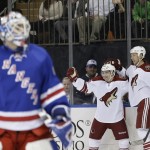 Arizona Coyotes' Mark Arcobello celebrates with David Moss, right, after scoring a goal on New York Rangers goalie Cam Talbot, left, during the first period of an NHL hockey game Thursday, Feb. 26, 2015, in New York. (AP Photo/Frank Franklin II)