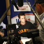 San Francisco Giants catcher Buster Posey talks to the media during baseball player availability at Kauffman Stadium in Kansas City, Mo., Monday, Oct. 20, 2014. The Kansas City Royals will host the San Francisco Giants in Game 1 of the World Series on Oct. 21. (AP Photo/Orlin Wagner)