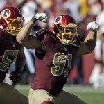 Washington Redskins outside linebacker Ryan Kerrigan (91) and inside linebacker Will Compton (51) celebrate Kerrigan's sack during the second half of an NFL football game against the Tennessee Titans, Sunday, Oct. 19, 2014, in Landover, Md. (AP Photo/Mark E. Tenally)