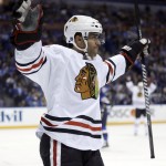 Chicago Blackhawks' Johnny Oduya, of Sweden, celebrates after scoring during the first period in Game 1 of a first-round NHL hockey Stanley Cup playoff series against the St. Louis Blues on Thursday, April 17, 2014, in St. Louis. (AP Photo/Jeff Roberson)
