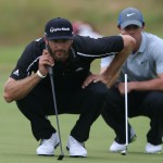 Dustin Johnson of the US, left, looks at his putt on the 15th green with Rory McIlroy of Northern Ireland at right during the third day of the British Open Golf championship at the Royal Liverpool golf club, Hoylake, England, Saturday July 19, 2014. (AP Photo/Jon Super)
