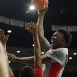 Arizona forward Stanley Johnson (5), right, shoots over Gardner Webb guard Adonis Burbage (23) during the second half of an NCAA college basketball game, Tuesday, Dec. 2, 2014, in Tucson, Ariz. (AP Photo/Rick Scuteri)