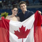 Ice dance silver medallists Canada's Tessa Virtue, left, and Scott Moir pose with the Canadian flag during the flowers ceremony for the ice dance free dance figure skating finals at the 2014 Sochi Winter Olympics, Monday, Feb. 17, 2014, in Sochi. (AP Photo/The Canadian Press, Paul Chiasson)