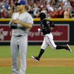 Arizona Diamondbacks' Cody Ross, right, rounds the bases after hitting a solo home run as Texas Rangers pitcher Martin Perez looks away during the fifth inning of an inter league baseball game, Monday, May 27, 2013, in Phoenix. (AP Photo/Matt York)