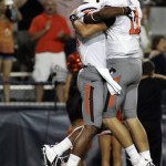 Oklahoma States' quarterback Wes Lunt (11) and Tracy Moore (87) celebrate Tracy's touchdown against Arizona during the first half of an NCAA college football game at Arizona Stadium in Tucson, Ariz., Saturday, Sept. 8, 2012. (AP Photo/John Miller)
