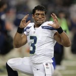 Seattle Seahawks quarterback Russell Wilson (3) warms up before an NFL football game against the St. Louis Rams, Monday, Oct. 28, 2013, in St. Louis. (AP Photo/Michael Conroy)