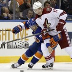 Phoenix Coyotes right wing Radim Vrbata, right, of Czech Republic, and New York Islanders center John Tavares compete for the puck in the first period of an NHL hockey game at Nassau Coliseum in Uniondale, N.Y., Tuesday, Oct. 8, 2013. (AP Photo/Kathy Willens)