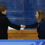 USA head coach Katey Stone knocks fists with an assistant coach at the end of play against Sweden during a 2014 Winter Olympics women's semifinal ice hockey game at Shayba Arena, Monday, Feb. 17, 2014, in Sochi, Russia. The USA won 6-1. (AP Photo/Julio Cortez)