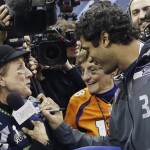 Seattle Seahawks' Russell Wilson signs autographs during media day for the NFL Super Bowl XLVIII football game Tuesday, Jan. 28, 2014, in Newark, N.J. (AP Photo/Mark Humphrey)