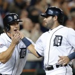 Detroit Tigers' Andy Dirks, left, congratulates Alex Avila after they both scored on a double by Omar Infante during the eighth inning of Game 4 of baseball's American League division series against the Oakland Athletics in Detroit, Tuesday, Oct. 8, 2013. (AP Photo/Paul Sancya)