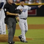 Umpire Tim Welke (3) stands next to Tampa Bay Rays manager Joe Maddon who calls for a new pitcher after pulling Chris Archer during the second inning of a baseball game against the Arizona Diamondbacks, Wednesday, Aug. 7, 2013, in Phoenix. (AP Photo/Matt York)