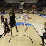 Louisville's Luke Hancock (11) shoots as Wichita State's Carl Hall (22) defends during the second half of the NCAA Final Four tournament college basketball semifinal game Saturday, April 6, 2013, in Atlanta. (AP Photo/NCAA Photos, Chris Steppig)
