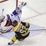 Boston Bruins left wing Brad Marchand (63) beats New York Rangers goalie Henrik Lundqvist (30) for the game-winning goal during overtime in Game 1 of an NHL hockey playoffs Eastern Conference semifinal in Boston, Thursday, May 16, 2013. Rangers right wing Mats Zuccarello (36), right, looks on The Bruins won 3-2. (AP Photo/Charles Krupa)