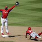 Washington Nationals' Billy Burns, right, steals second base as Philadelphia Phillies' Yuniesky Betancourt leaps for the throw during the sixth inning of a spring training baseball game, Wednesday, March 6, 2013, in Clearwater, Fla. Philadelphia won 6-3. (AP Photo/Matt Slocum)